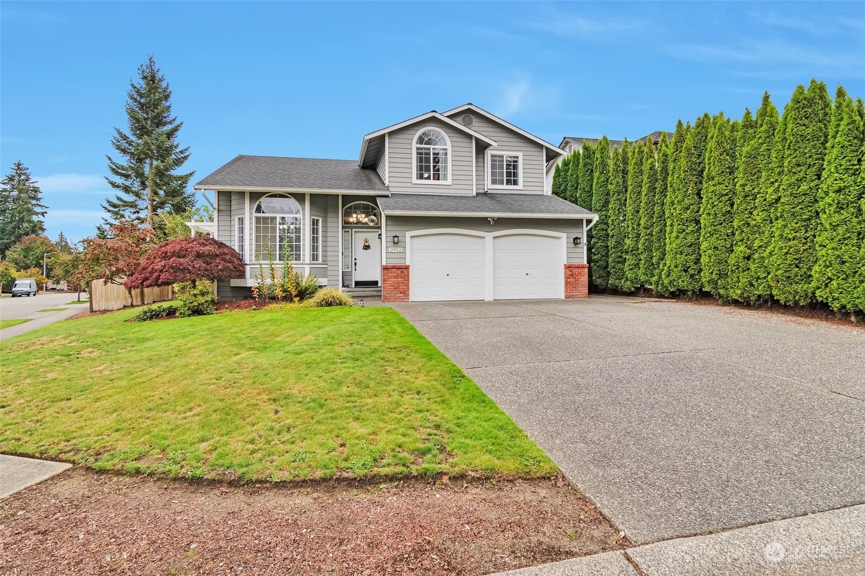 a front view of a house with a yard and garage