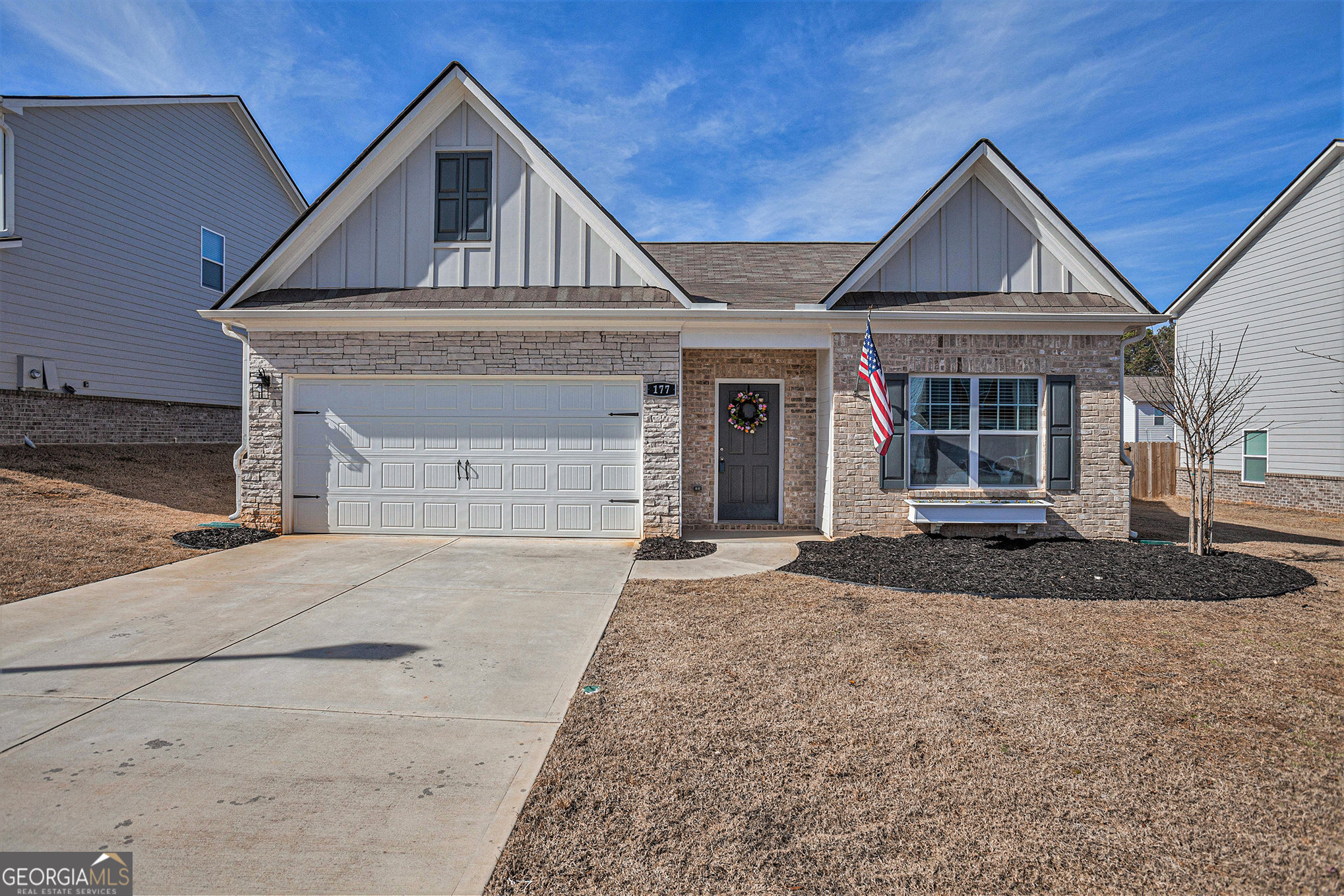 a front view of a house with a yard and garage