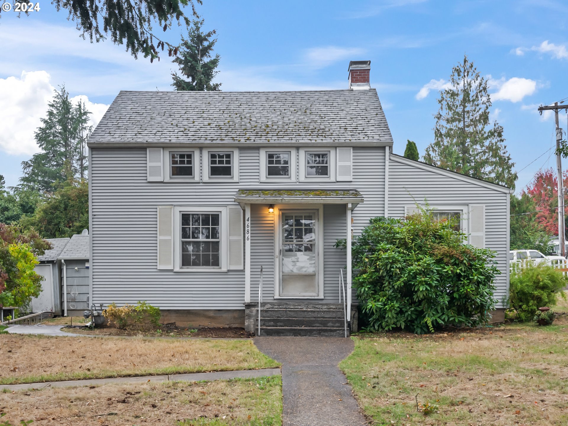 a front view of a house with garden