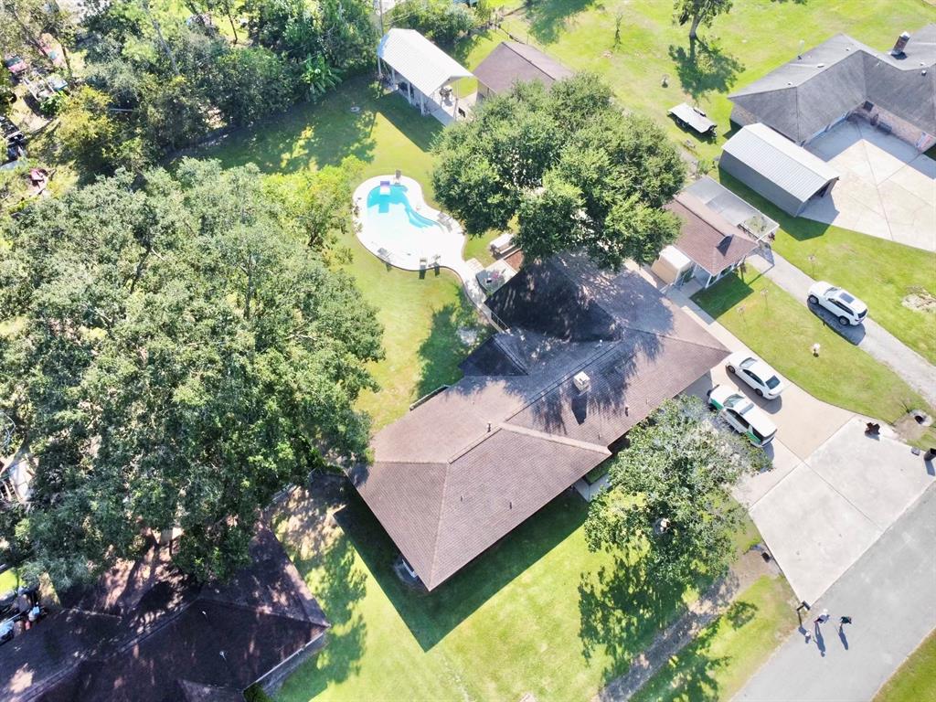 an aerial view of a house with a garden and swimming pool