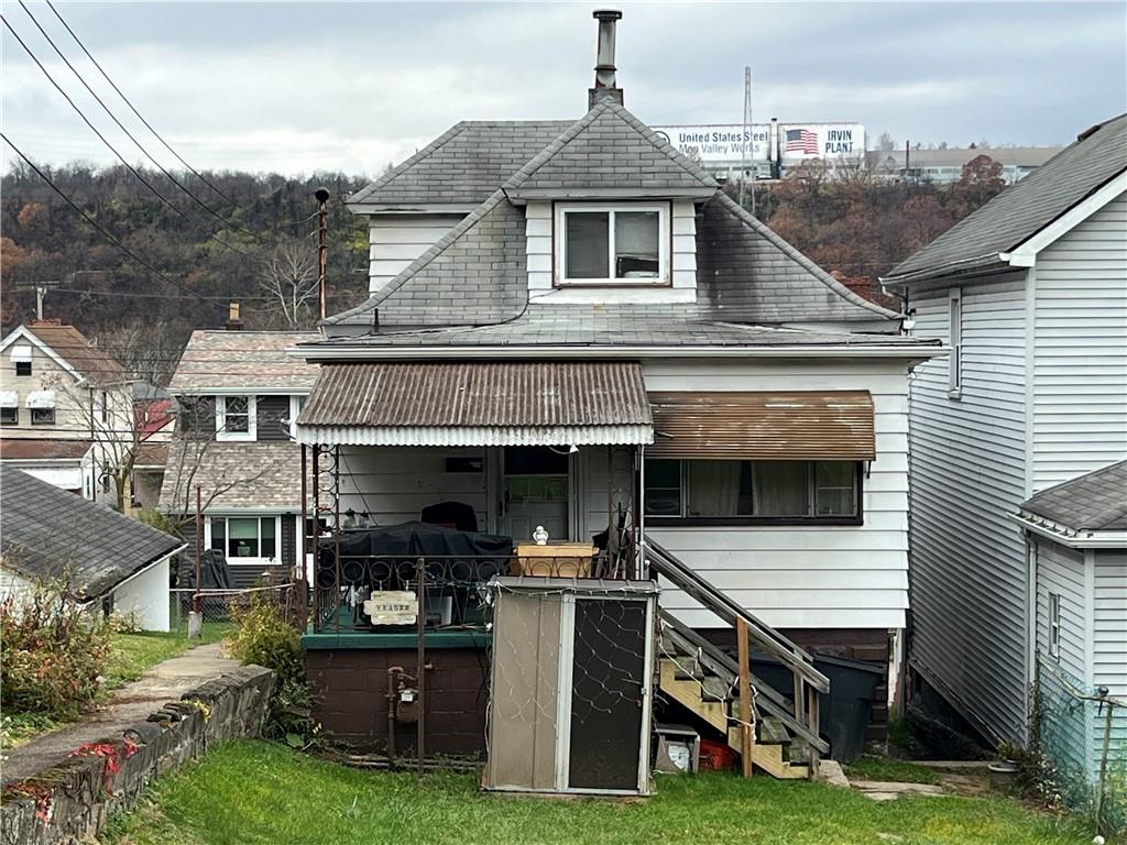 a view of house with yard