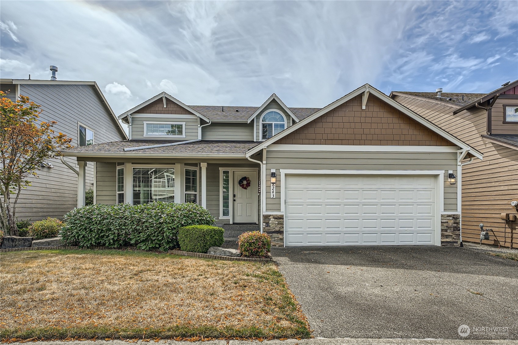 a front view of a house with a yard and garage