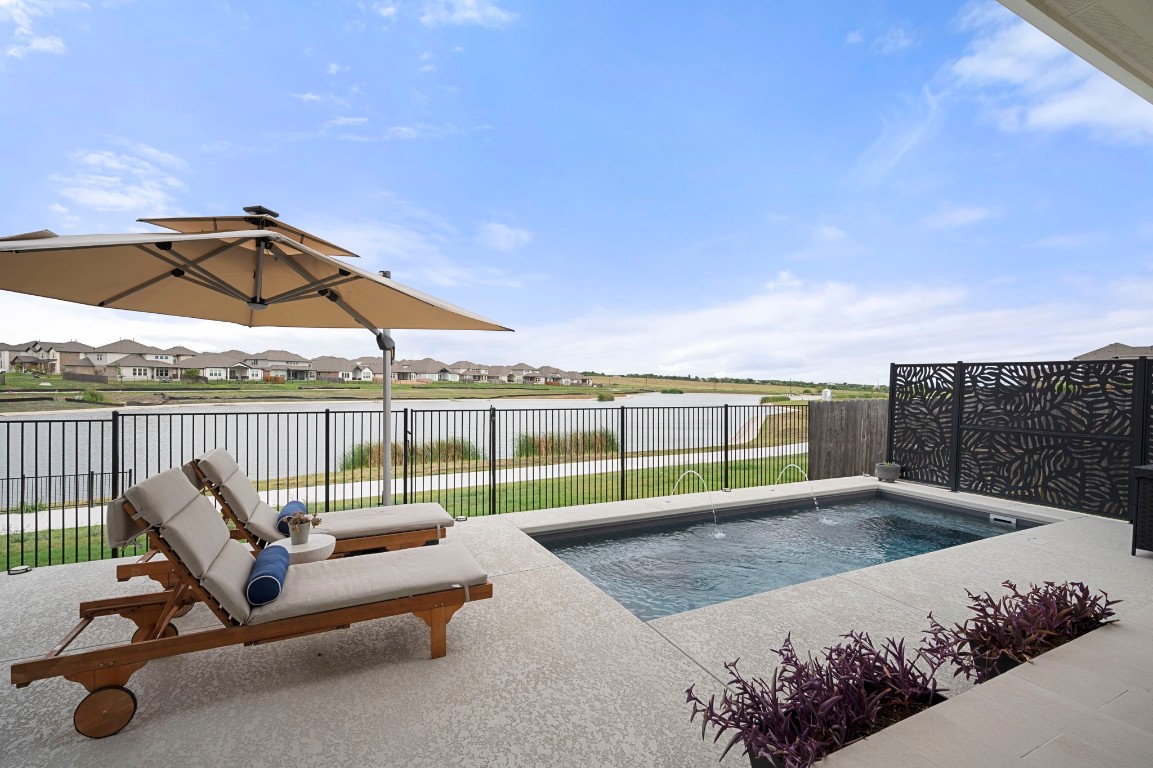 a view of a swimming pool with a lounge chair