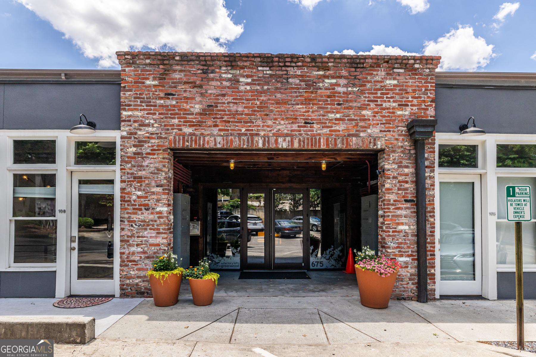 a front view of a building with outdoor seating