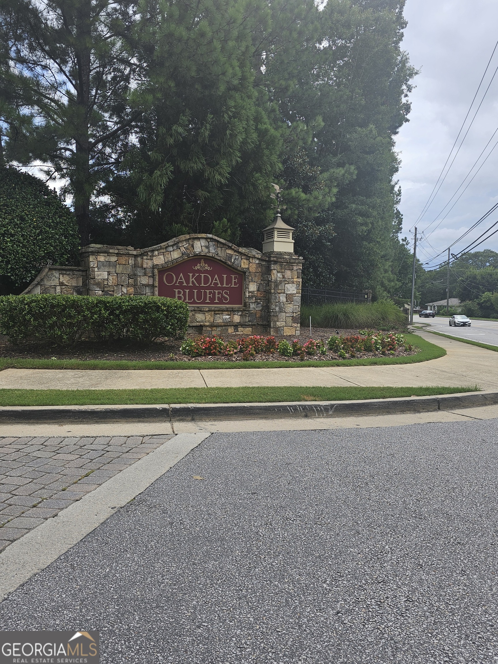 a view of a house with a yard and a large parking space