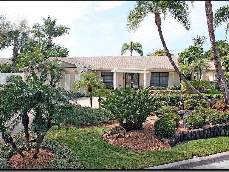 a front view of a house with a garden