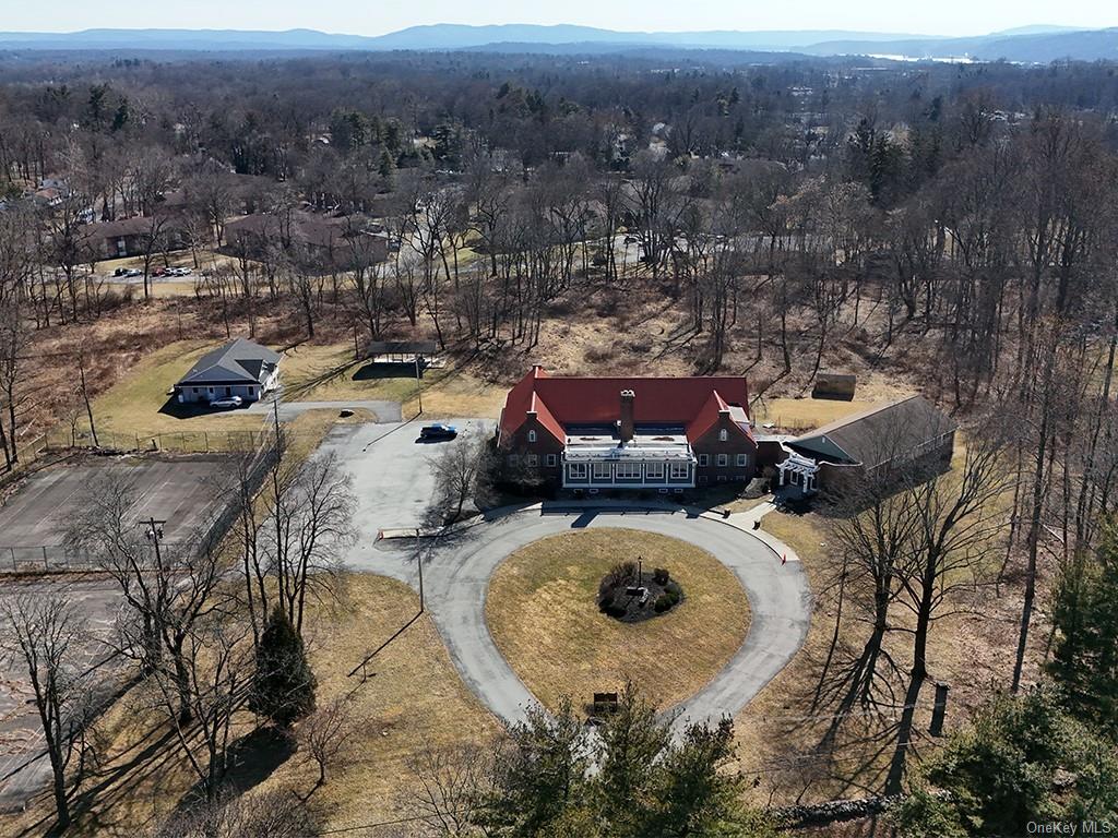 an aerial view of a house with garden space and street view