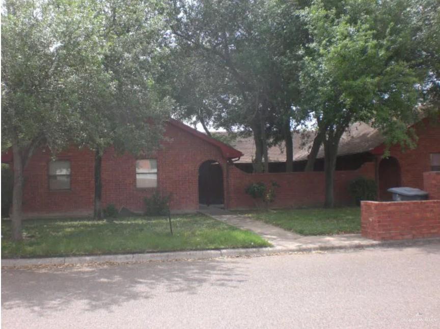 a front view of a house with a yard and a garage