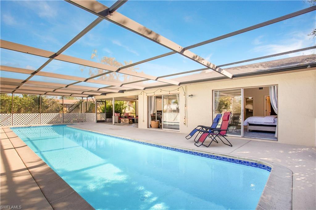 a view of a backyard with table and chairs under an umbrella