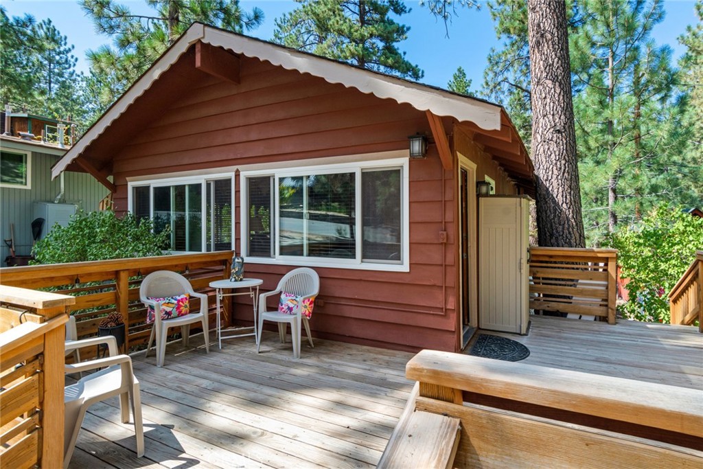 a view of house with deck and outdoor seating