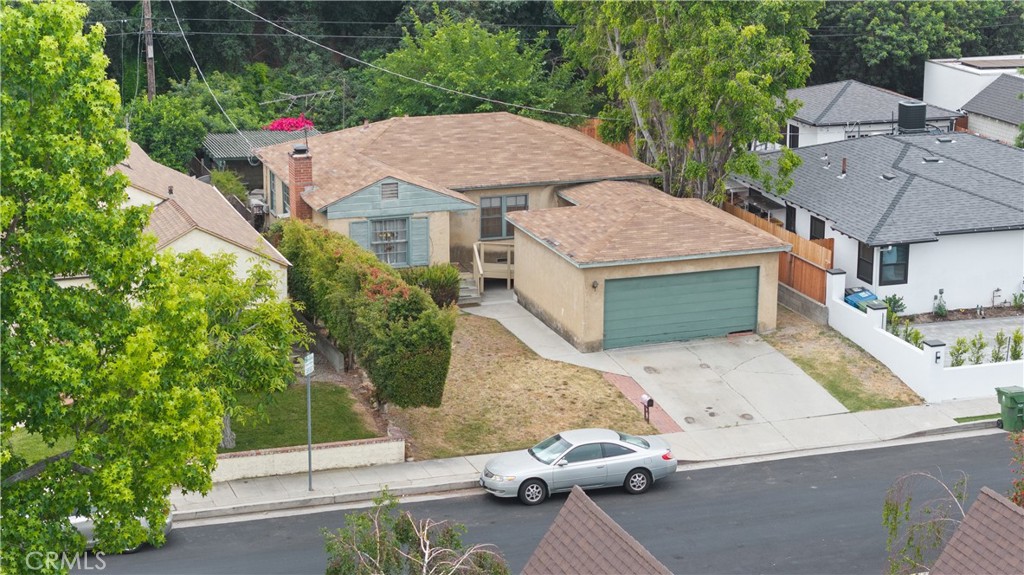 an aerial view of a house with garden space and sitting area