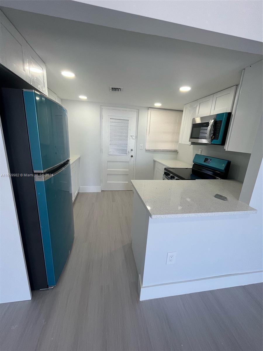 a kitchen with stainless steel appliances a refrigerator and a sink