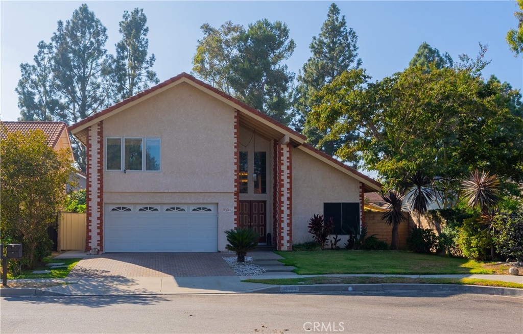 a view of a house with a yard and garage