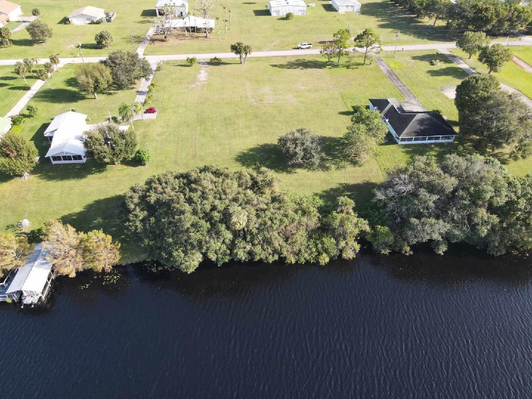 a view of a lake with lawn chairs