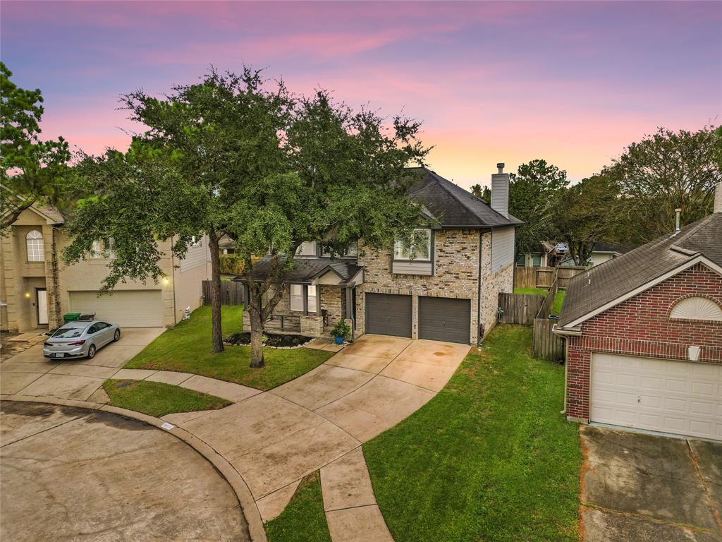 a view of a house with a yard and tree s