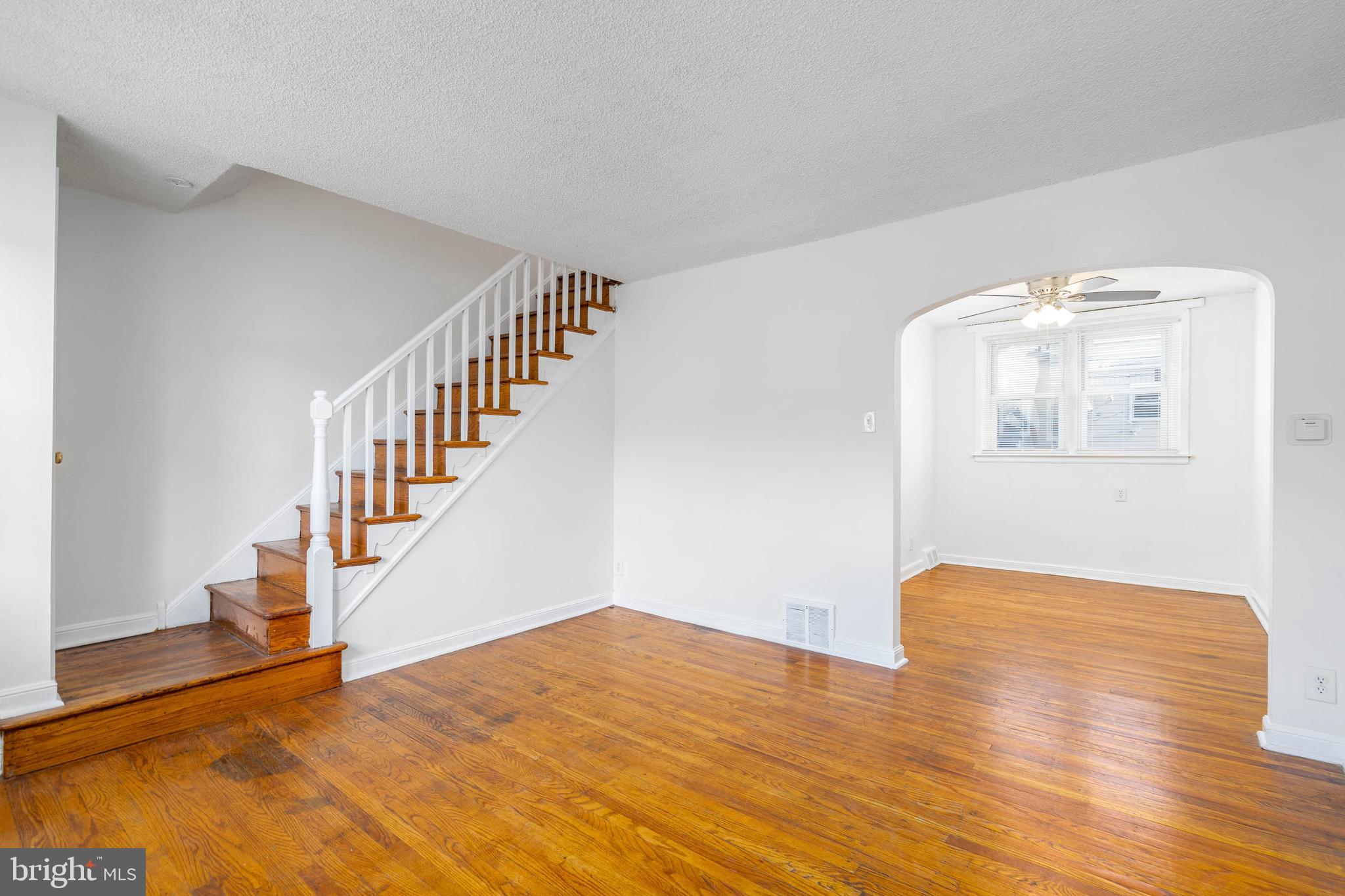 a view of an empty room with wooden floor