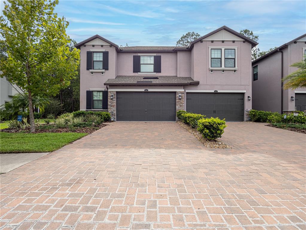 a front view of a house with a yard and garage