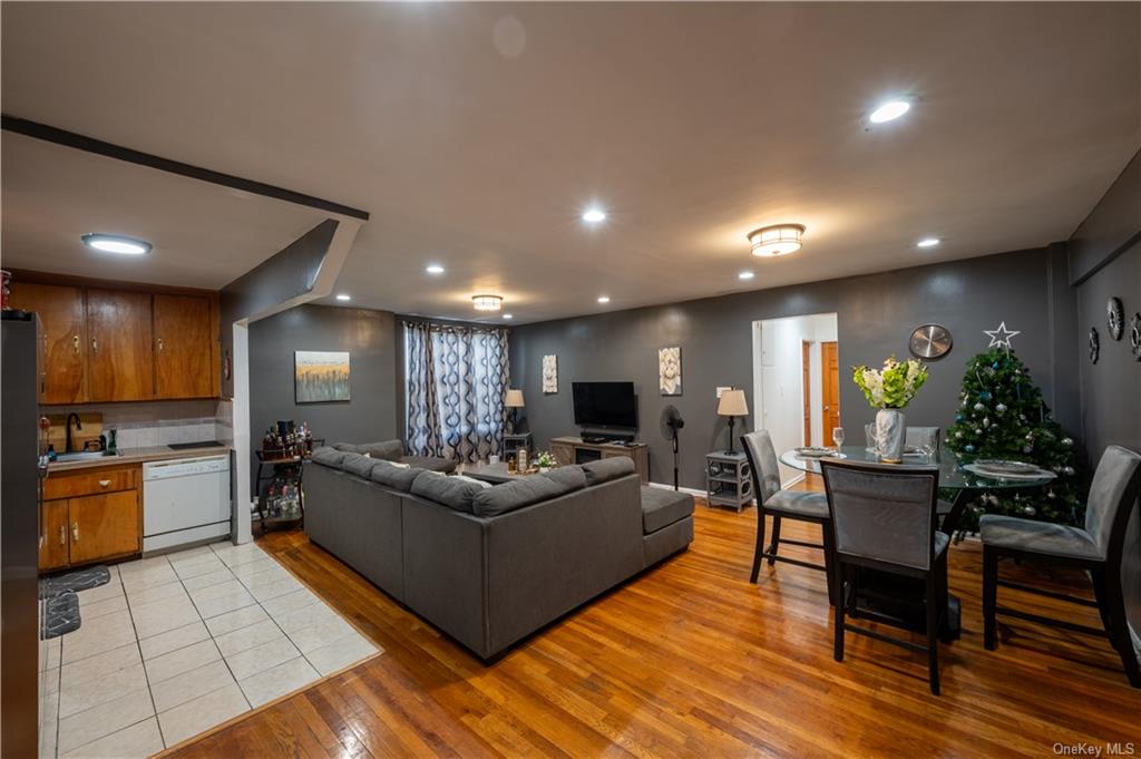 Living room with light hardwood / wood-style floors and sink