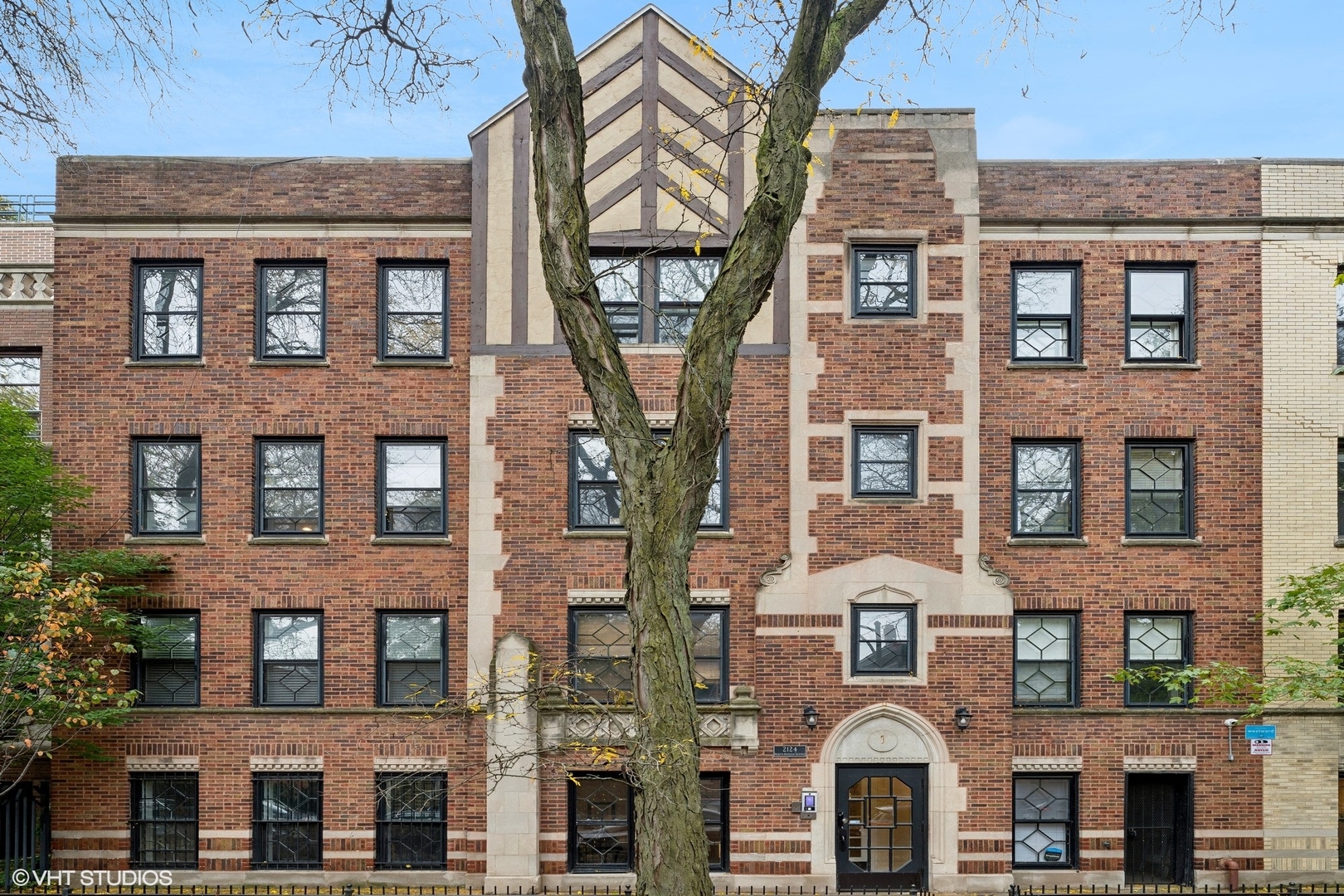 a front view of a residential apartment building with a yard