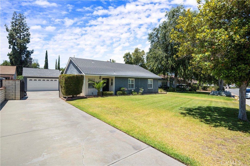 a front view of house with yard and green space