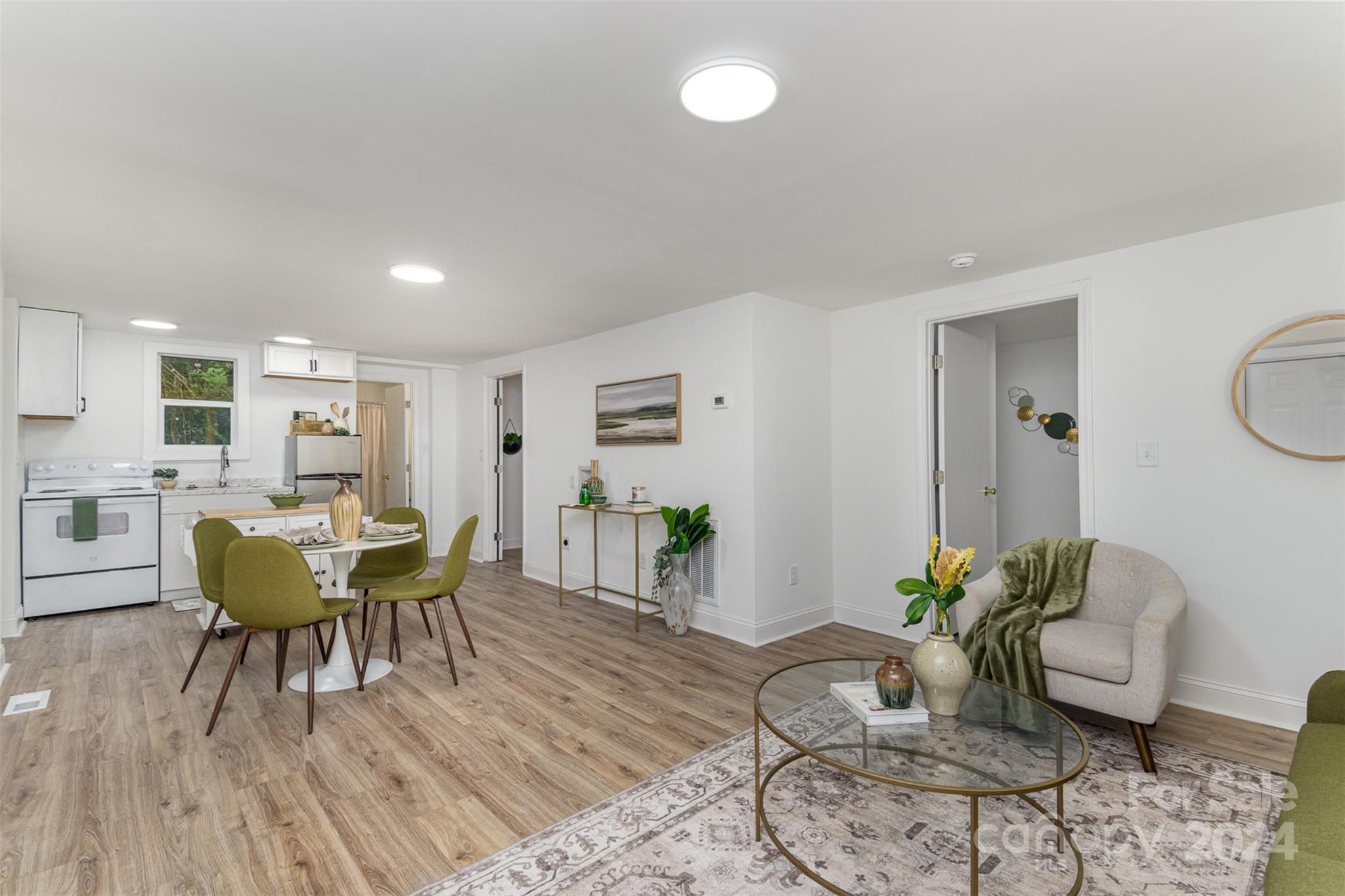 a living room with furniture and wooden floor