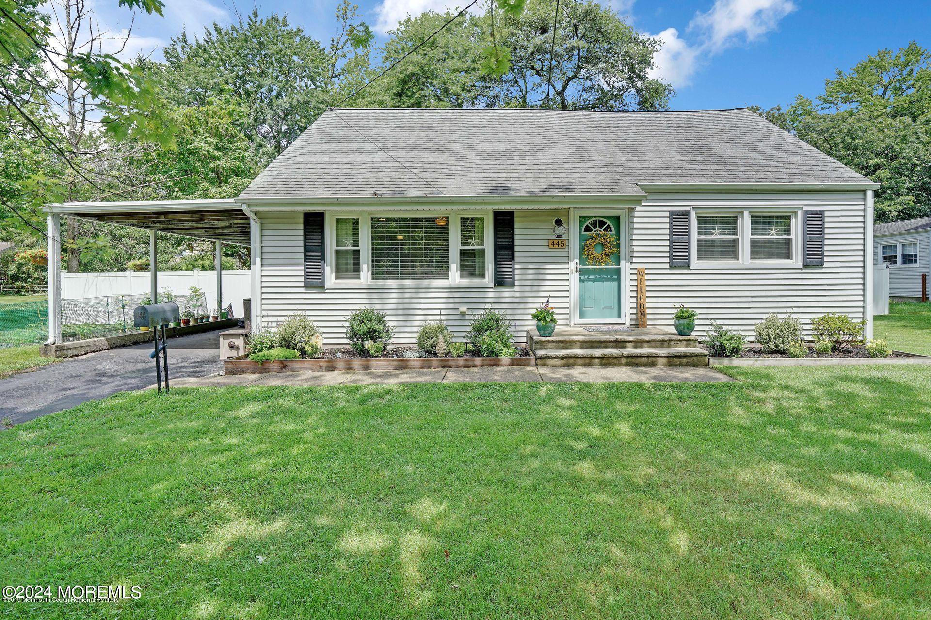 a front view of house with yard and outdoor seating