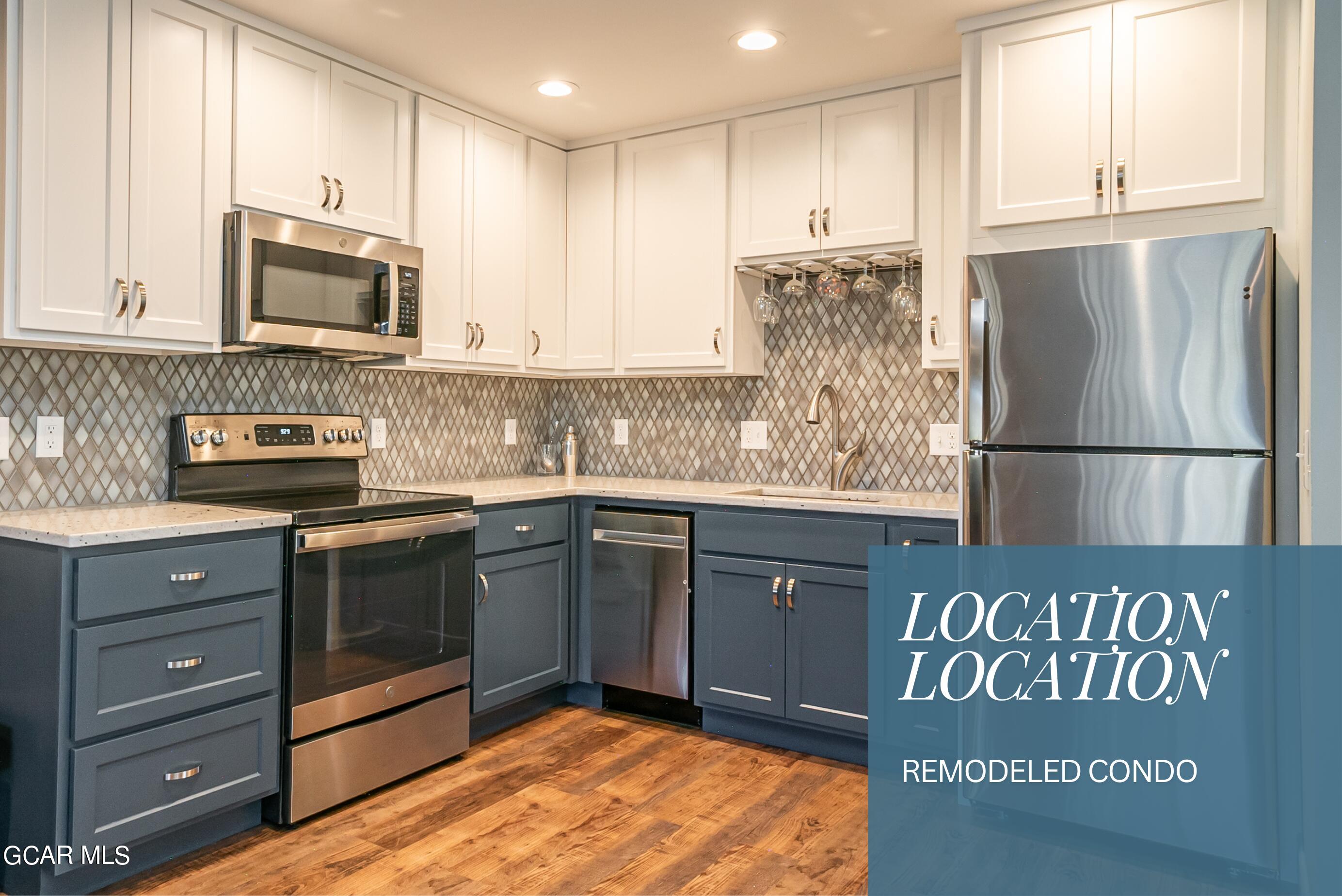 a kitchen with granite countertop stainless steel appliances and wooden cabinets