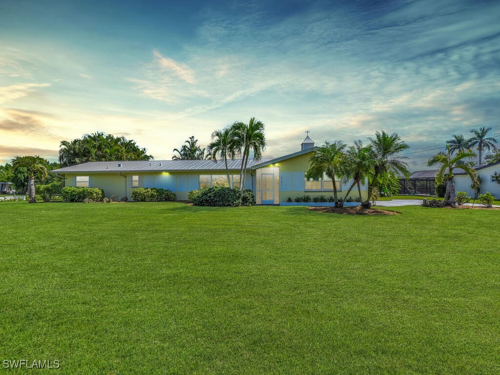 a view of house with garden space and lake view