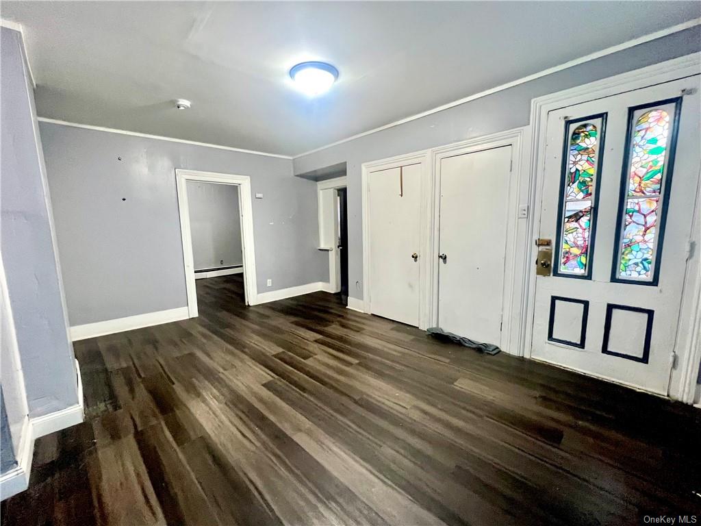 a view of a hallway with wooden floor and windows