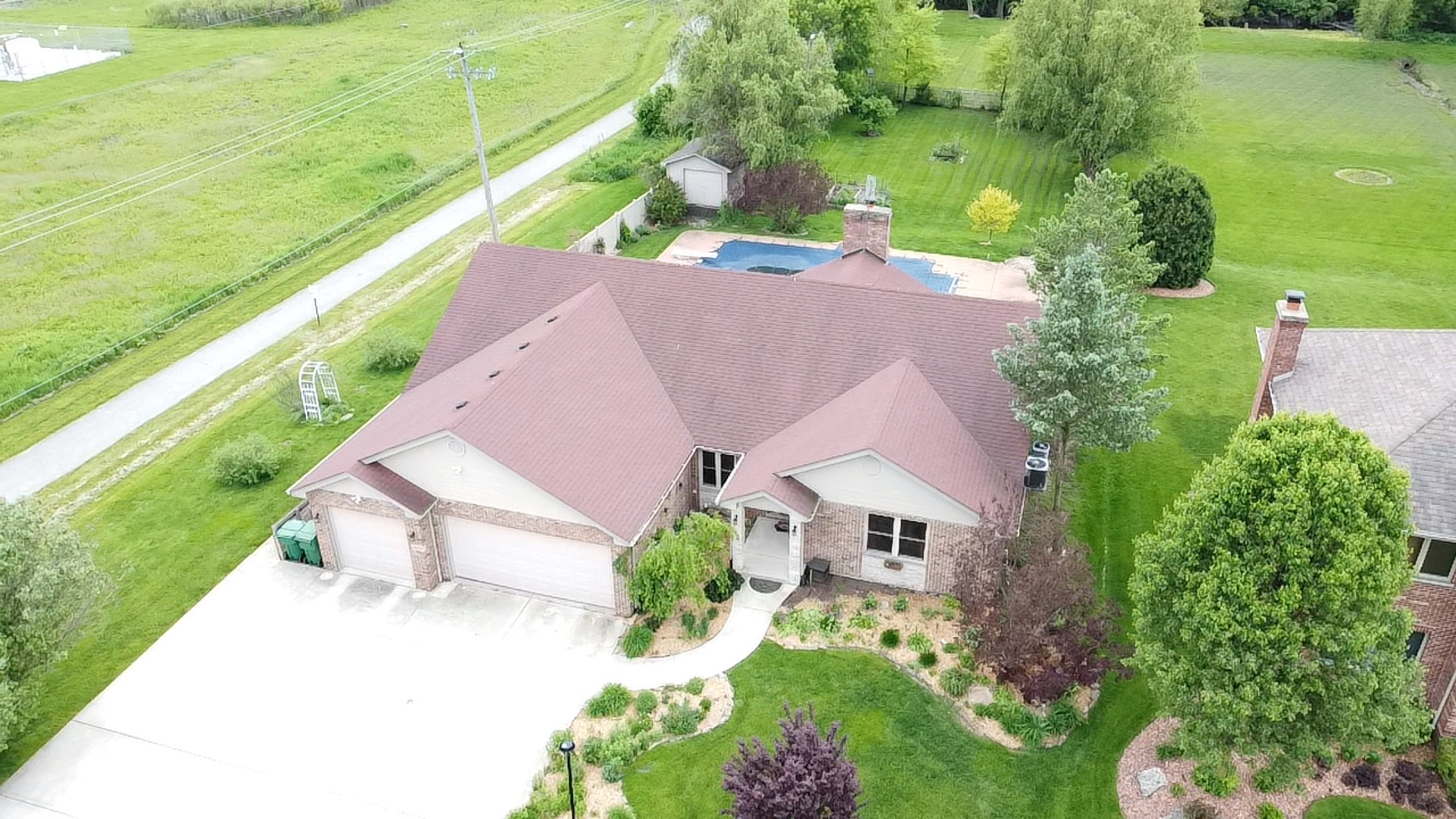 an aerial view of house with yard swimming pool and outdoor seating