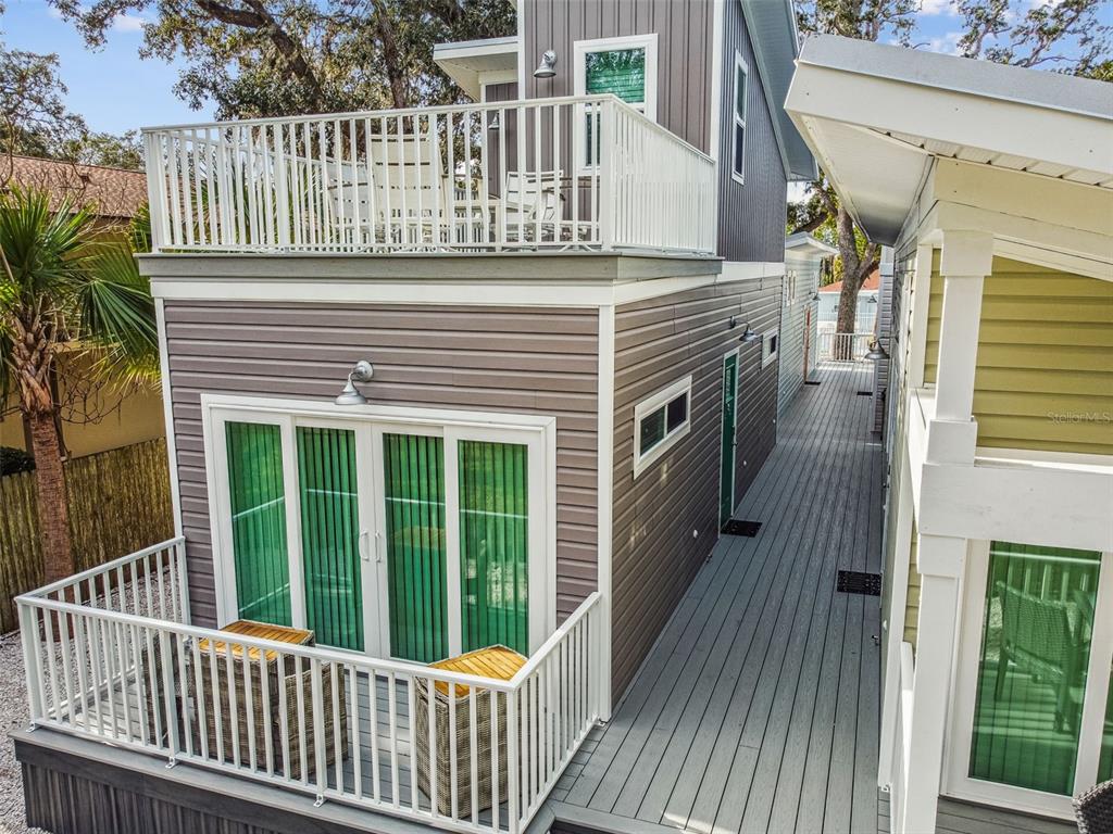 a view of a house with a wooden deck