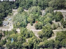 an aerial view of residential house with outdoor space and trees all around