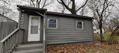 a view of a house with a door and wooden deck