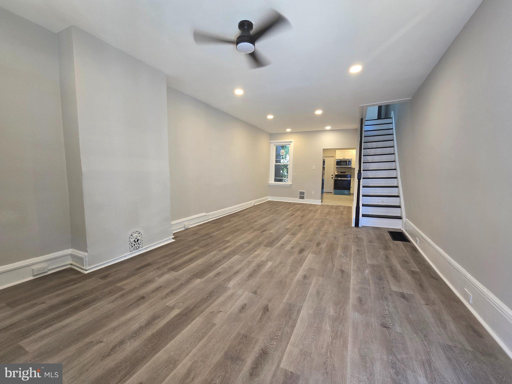 wooden floor in an empty room with a window