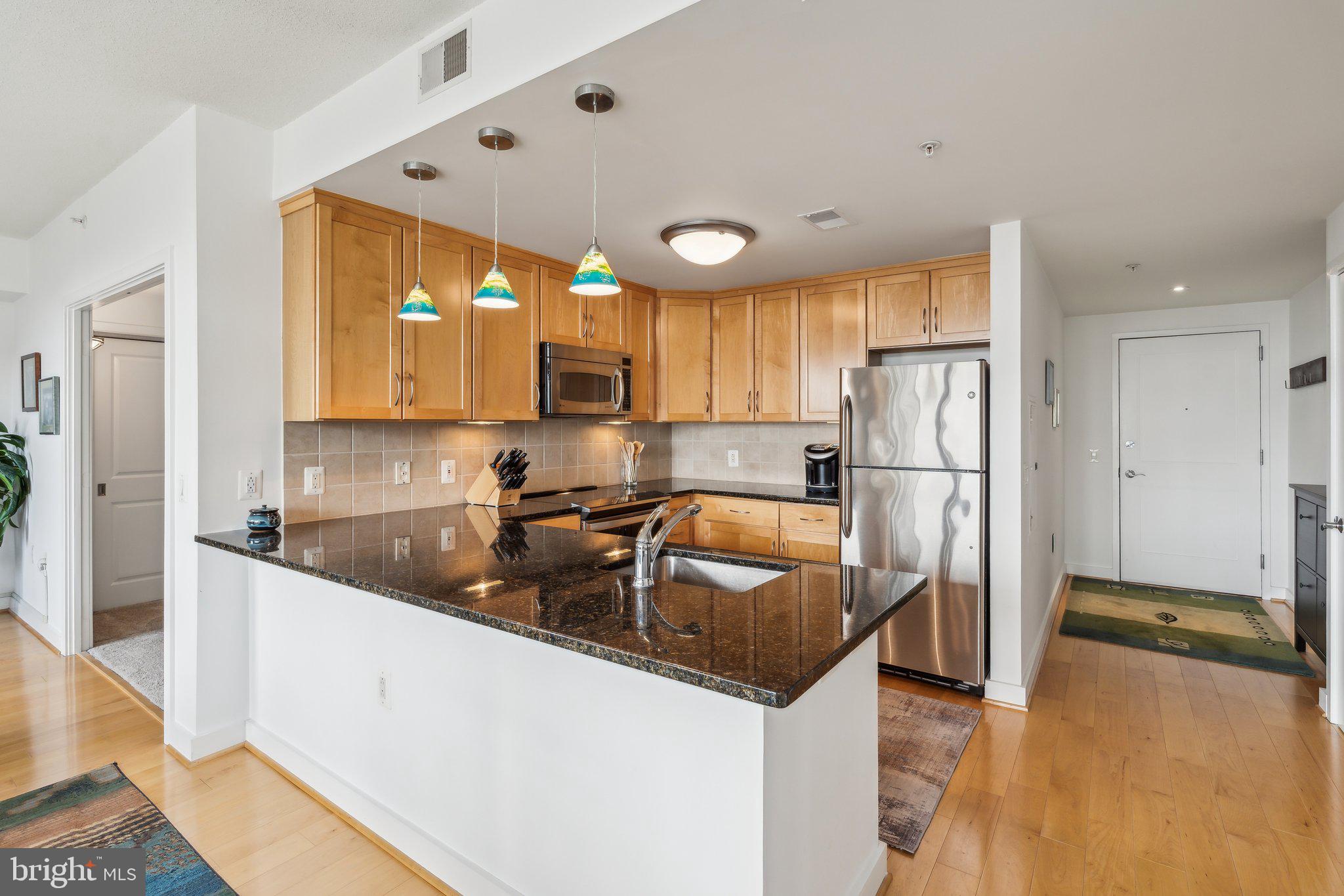 a kitchen with refrigerator and cabinets