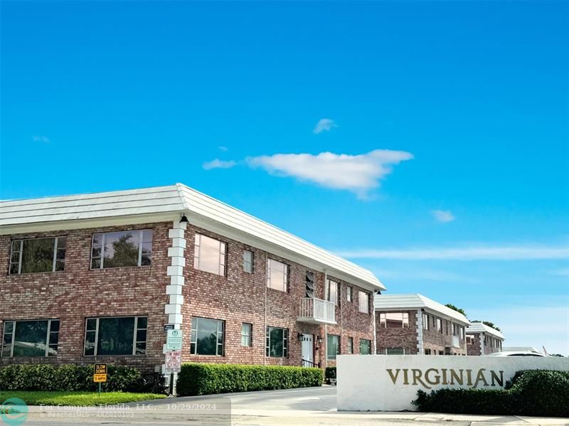 a front view of a building with garden