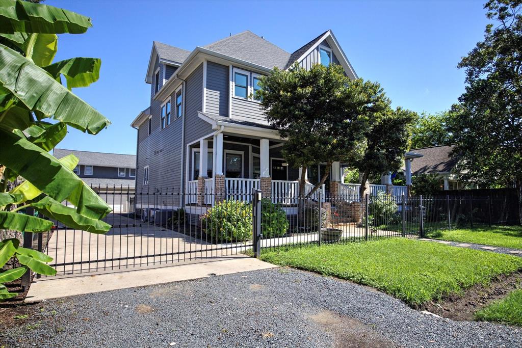 a front view of a house with a garden and plants