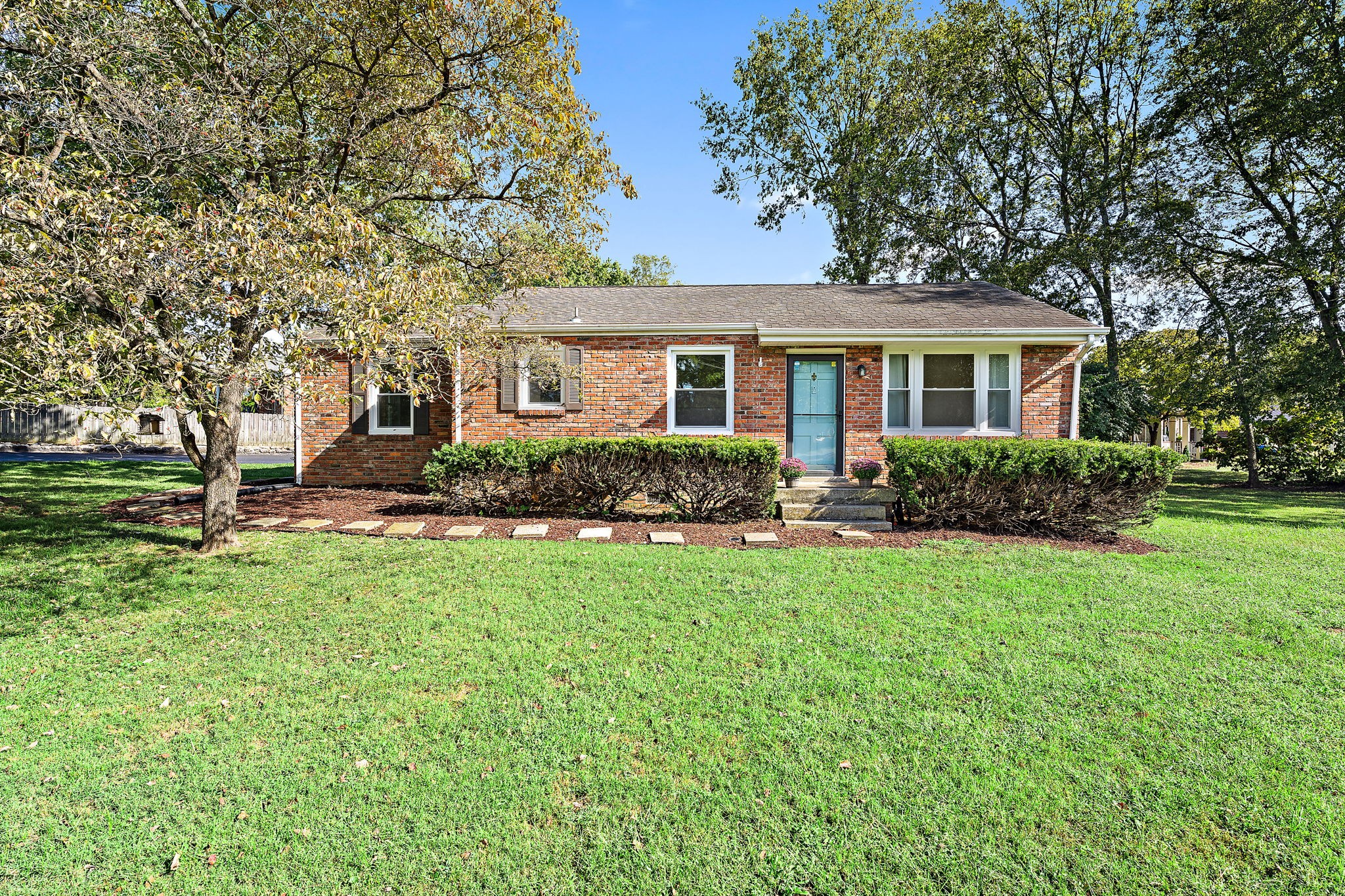 a front view of house with yard and green space