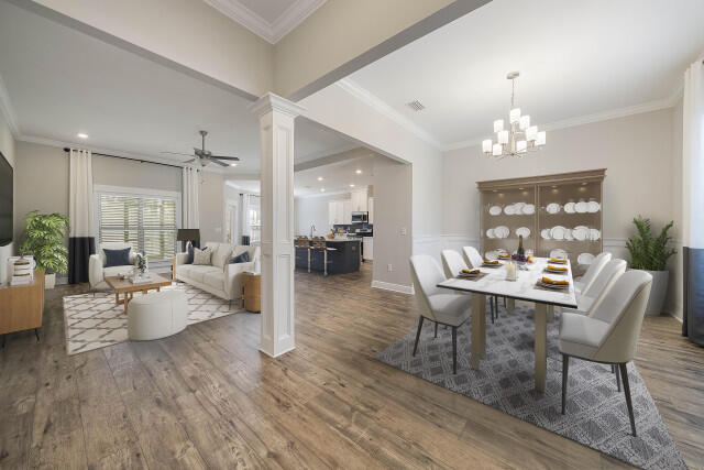 a view of a dining room with furniture wooden floor and chandelier