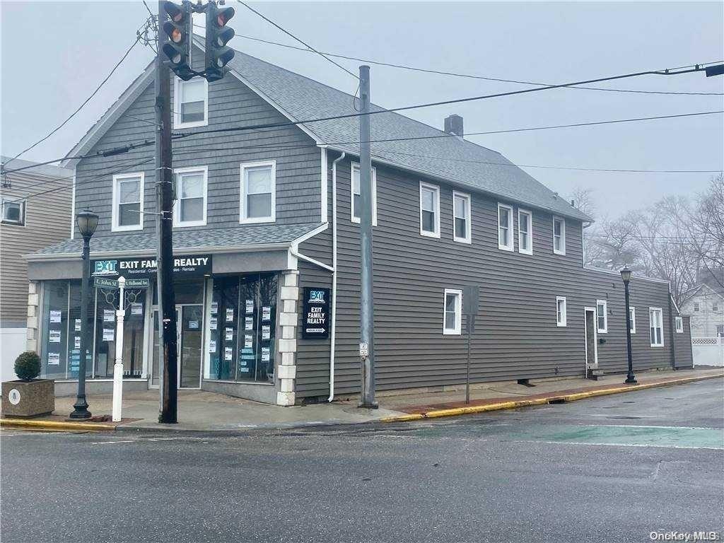 a front view of a house with a road