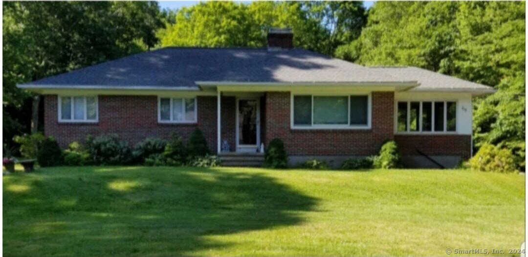 a view of house with yard and green space