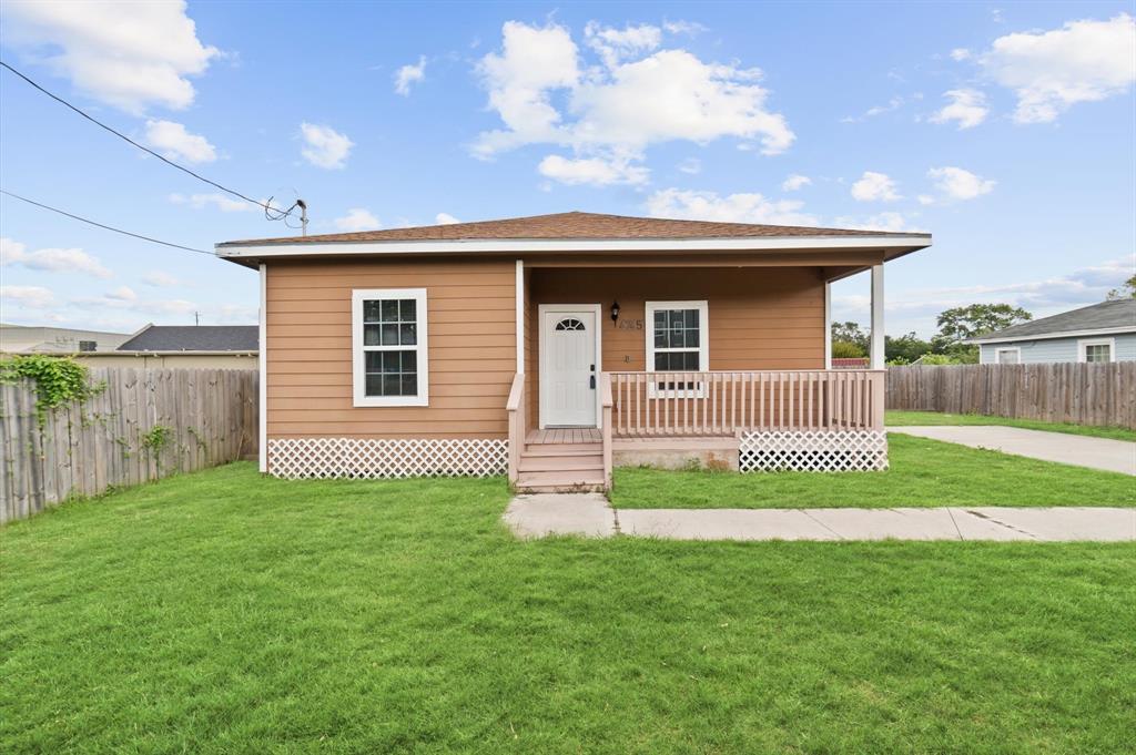 a front view of a house with a yard and fence