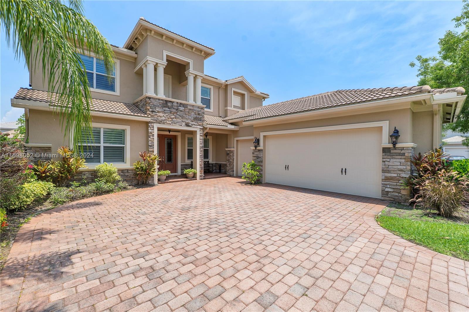 front view of a house with a yard and a garage