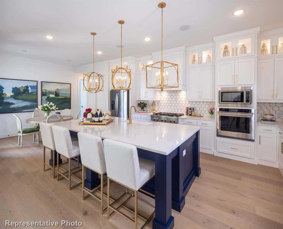 a large kitchen with a table and chairs