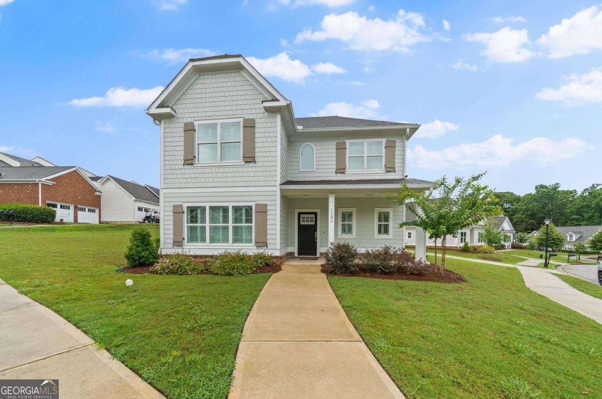 a front view of house with yard and green space