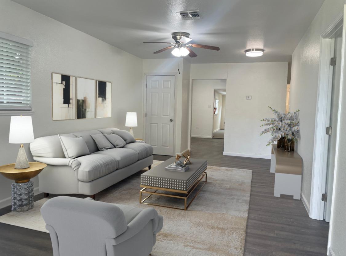 a living room with furniture and a chandelier