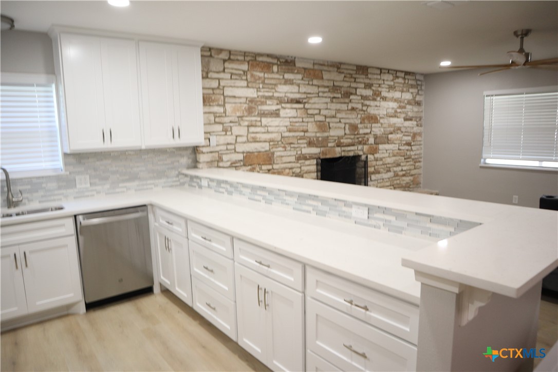 a kitchen with granite countertop a sink and a stove