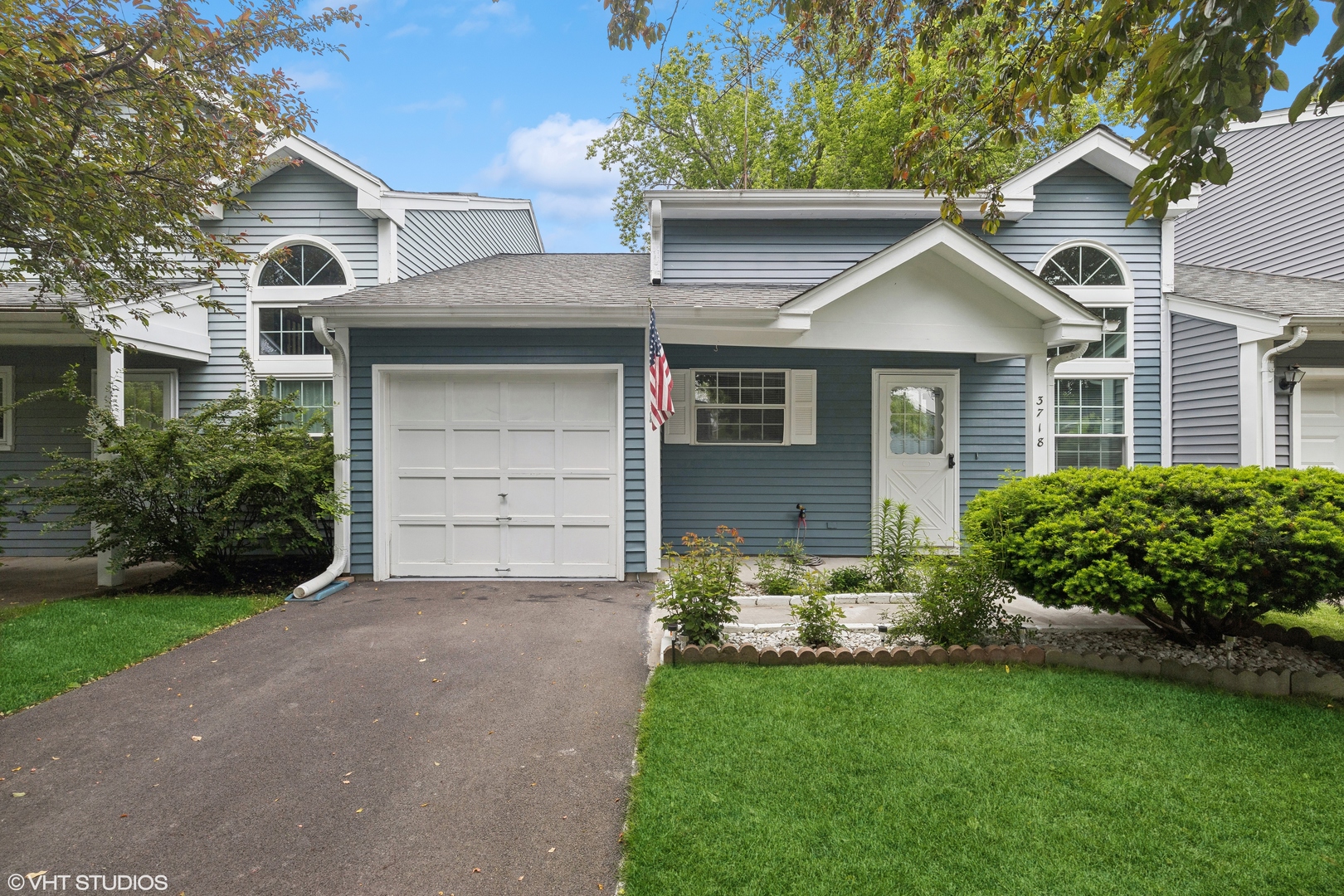 a front view of a house with a yard and garage