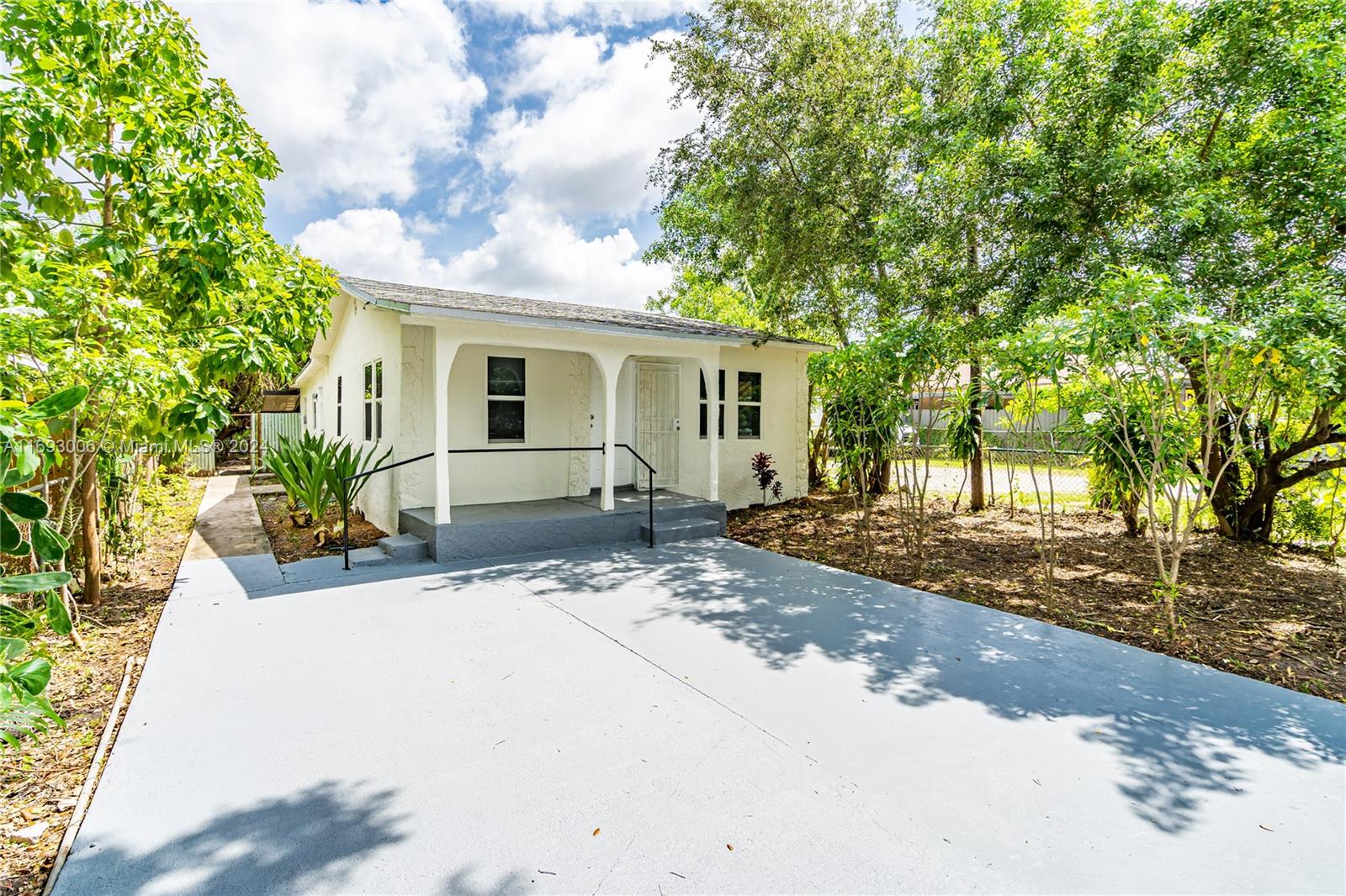 a view of a house with a tree in front