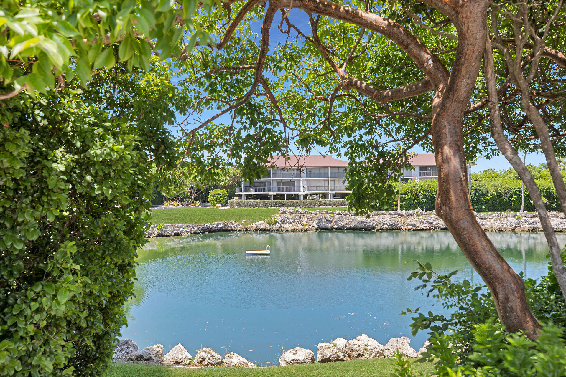 a view of a lake with a house in the background